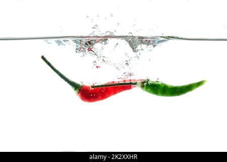 Red chilli, water splashes, solated on a white background Stock Photo
