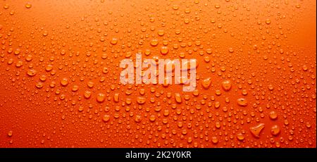 Water drops on orange surface Stock Photo