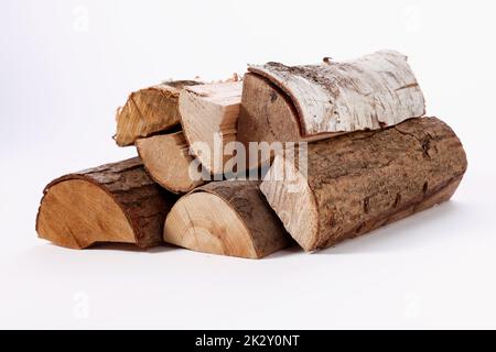 Stack of cut assorted tree trunks on white surface Stock Photo