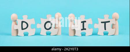 The words do it are standing on two puzzle pieces, positive mindset, motivation and coaching concept, believe in yourself Stock Photo