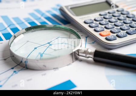 Magnifying glass on charts graphs paper. Financial development, Banking Account, Statistics, Investment Analytic research data economy, Stock exchange trading, Business office company meeting concept. Stock Photo