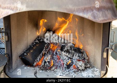 Burning wood in a fireplace with a lot of embers Stock Photo