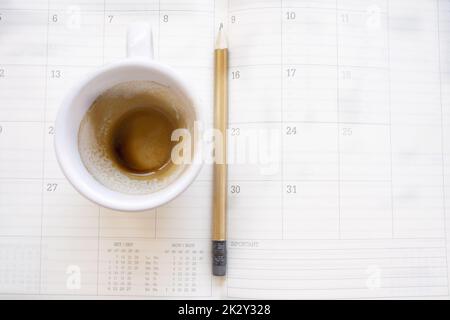 empty cup of coffee on a work diary Stock Photo