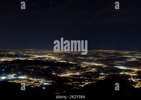 Plain illuminated partially covered by fog, soft lights Stock Photo