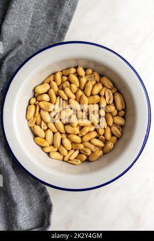 Roasted peeled peanuts in bowl. Stock Photo