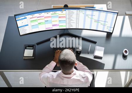 Man Working On Calendar Agenda Schedule On Computer Stock Photo