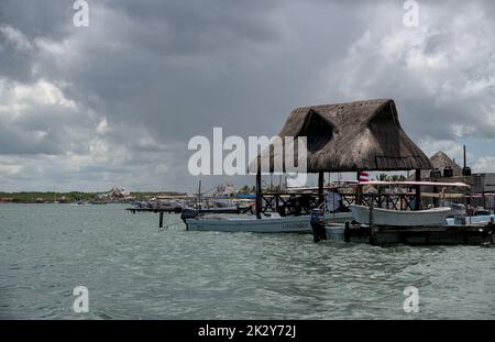 Coastal view of fishing and tourism sight seeing boats docked in Mexico. Taking tourists to see wildlife refuge on vacation. Stock Photo