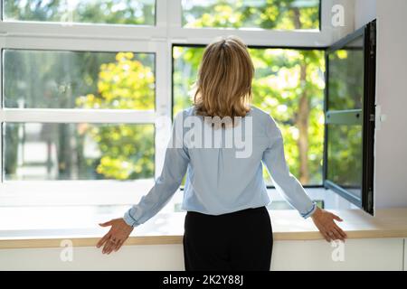 Fresh Air From Window. Rear View Of Woman Relaxing Stock Photo