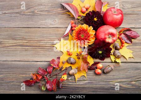 Composition of colorful fruits, berries, cones. Top view on wooden background. Autumn flat lay. Stock Photo