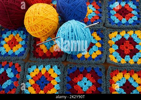 Granny squares. Crocheting supplies, colored wool yarn and knitting crocheting Stock Photo