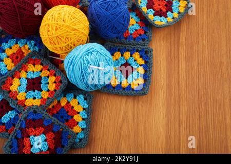 Granny squares. Crocheting supplies, colored wool yarn and knitting crocheting Stock Photo