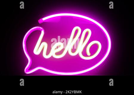 Hello word text - bright neon on electric purple color background Stock Photo