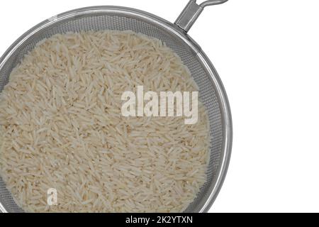 Raw white rice in a colander strainer isolated on white background Stock Photo
