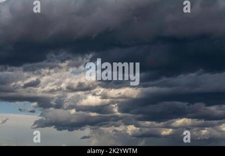 Thick dark clouds on blue sky Stock Photo