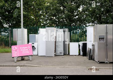 Old fridges freezers wash machines and kitchen appliances at rubbish dump Stock Photo