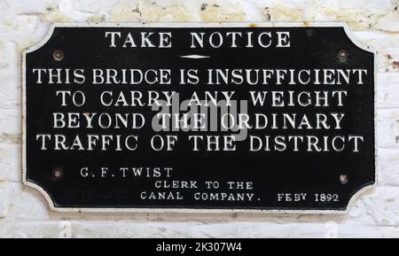 Black sign, Take Notice, This bridge is insufficient to carry any weight,beyond the ordinary traffic of the district, GF Twist Feby 1892 Stock Photo