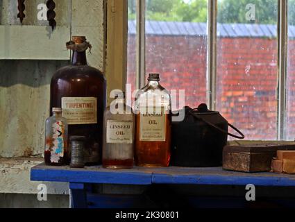 Bottles of Tool shed Oils, Linseed ,Turpentine on a shelf Stock Photo