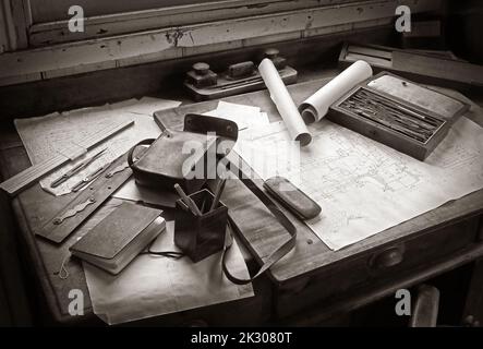 Monochrome old fashioned draughtsman's desk, blueprint, engineering drawing, pencils, instruments, rule, office desk ink & tools Stock Photo