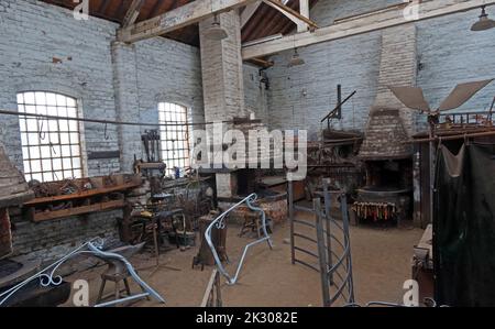 Interior of blacksmiths shop, forge, ironwork, casting, shaping, canalside works, Cheshire, England, UK Stock Photo