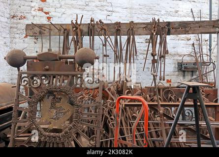 Interior of blacksmiths shop, forge, ironwork, casting, shaping, canalside works, Cheshire, England, UK Stock Photo