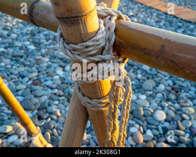 Green Bamboo Knotted With Rope Stock Photo - Download Image Now - Stick -  Plant Part, Tied Knot, Tied Up - iStock