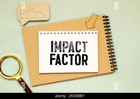 IMPACT FACTOR text written on sticky with pencil and glasses. Stock Photo