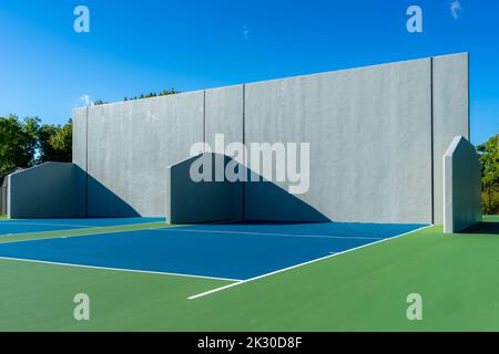 Example of an outside American Handball courts with concrete wall, located at a park or school. Stock Photo