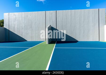 Example of an outside American Handball courts with concrete wall, located at a park or school. Stock Photo