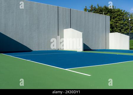 Example of an outside American Handball courts with concrete wall, located at a park or school. Stock Photo