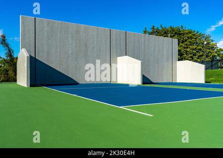 Example of an outside American Handball courts with concrete wall, located at a park or school. Stock Photo