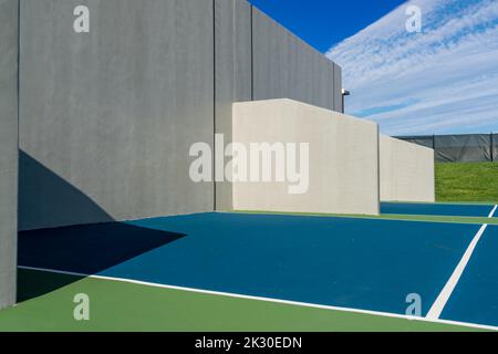 Example of an outside American Handball courts with concrete wall, located at a park or school. Stock Photo