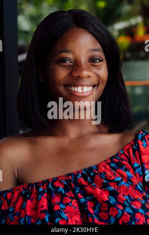 Happy young woman wearing off shoulder top Stock Photo