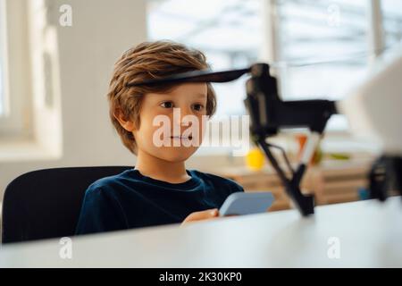 Boy operating drone with remote at home Stock Photo
