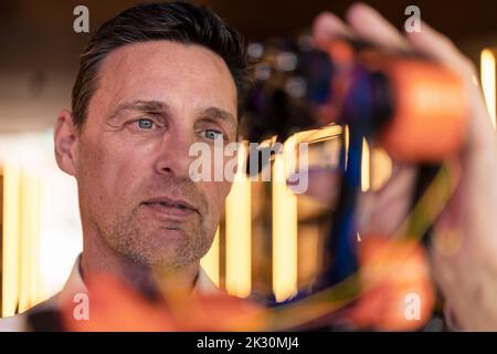 Engineer analyzing robotic arm at workshop Stock Photo