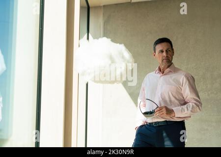 Businessman with smart glasses standing in office Stock Photo