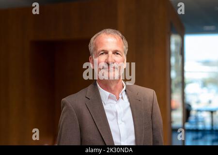 Confident senior businessman wearing blazer in office Stock Photo