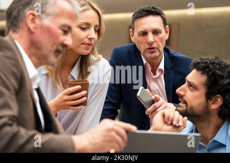 Business colleagues discussing strategy over tablet computer Stock Photo