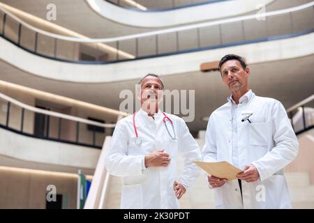 Thoughtful doctors with report document in hospital Stock Photo
