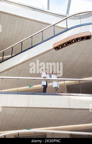 Doctors standing in corridor at hospital Stock Photo