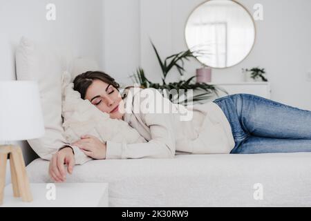 Young woman sleeping on bed at home Stock Photo