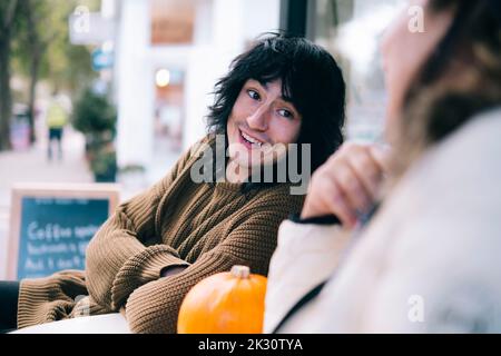 Son and mother having conversation at cafe Stock Photo