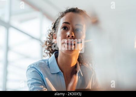 Customer service representative talking through headset Stock Photo