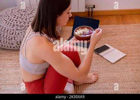 Woman eating healthy breakfast at home Stock Photo