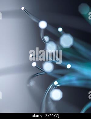 Illuminated optical fibers on gray background Stock Photo