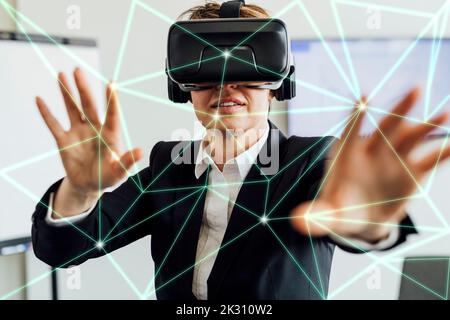 Businesswoman wearing smart glasses working on transparent screen Stock Photo