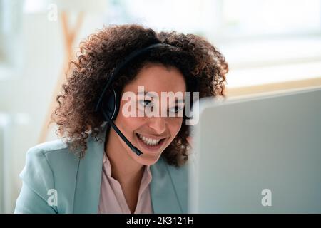 Smiling customer service representative wearing headset at workplace Stock Photo