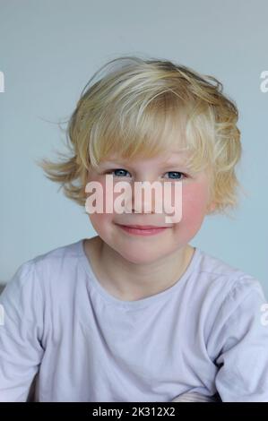 Portrait of cute smiling girl with blond hair Stock Photo - Alamy