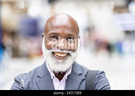 Smiling bald senior businessman with beard Stock Photo