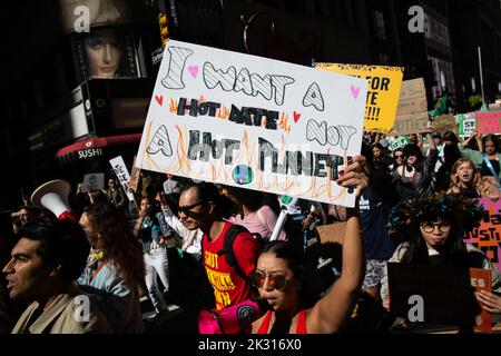 New York City, United States. 23rd Sep, 2022. Protester yells into the megaphone holding placard reading, "I want a hot date not a hot planet" during the climate strike. Hundreds of youth climate protesters marched from Foley Square to Battery Park with Fridays for the Future International Climate Strike. Credit: SOPA Images Limited/Alamy Live News Stock Photo