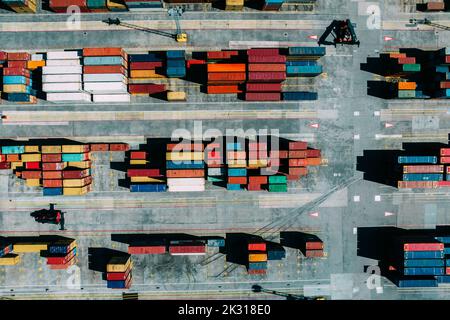 Aerial drone top down view of containers spread across a busy port, logistic and international trade concept Stock Photo
